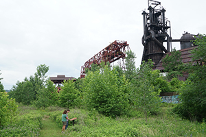 visitors read an Iron Garden cast
                                  sign while walking an edited path to
                                  the furnaces
